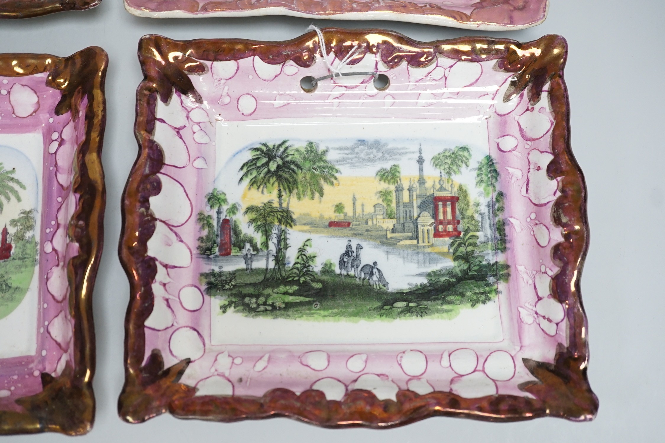 A set of four Dixon and Co. Sunderland pink lustre rectangular plaques, with copper lustre borders printed and hand coloured, impressed marks, 22cm wide